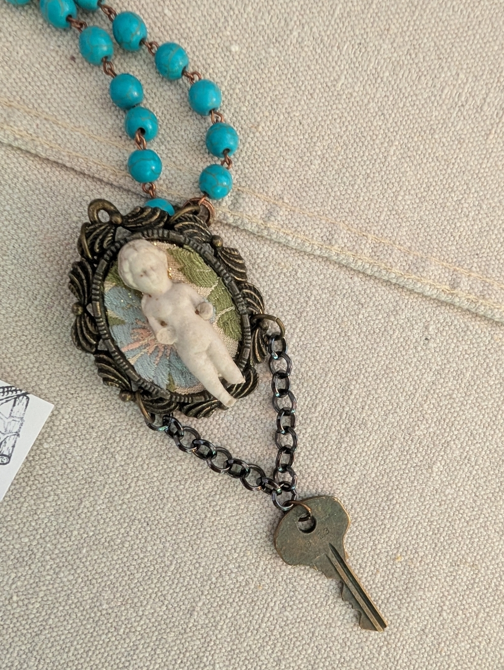 Sweet mini doll on pendant necklace, mixed media w vintage Frozen Charlotte